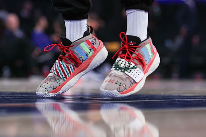 Milwaukee Bucks guard Damian Lillard's white, red, and black adidas sneakers.